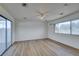 Well lit room with a ceiling fan, sliding glass doors, and large windows at 3785 Decade St, Las Vegas, NV 89121