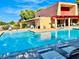 Relaxing community pool under a clear blue sky, complete with lounge chairs and inviting water at 3785 Decade St, Las Vegas, NV 89121