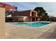 Beautiful community pool featuring sparkling water and poolside lounging area with modern architectural elements at 3785 Decade St, Las Vegas, NV 89121