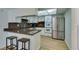 Bright kitchen with stainless steel appliances and breakfast bar with stool seating at 3785 Decade St, Las Vegas, NV 89121