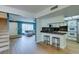 Open concept living space showcasing kitchen with breakfast bar and living room beyond at 3785 Decade St, Las Vegas, NV 89121