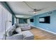 Spacious living room with sleek wood floors, modern lighting, and comfortable sofa with blue accents at 3785 Decade St, Las Vegas, NV 89121