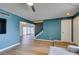 Bright living room showcasing wood floors, modern lighting, and easy access to other rooms at 3785 Decade St, Las Vegas, NV 89121