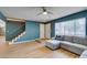 Bright living room showcasing wood floors, modern lighting, staircase and view of kitchen at 3785 Decade St, Las Vegas, NV 89121