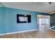 Bright living room features a large television, hardwood floors and a large sliding glass door at 3785 Decade St, Las Vegas, NV 89121