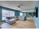 Comfortable living room features wood floors, modern lighting, and plush sofa with accent pillows at 3785 Decade St, Las Vegas, NV 89121