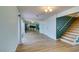 Open-concept living area with hardwood floors and view to the kitchen and stairs at 3785 Decade St, Las Vegas, NV 89121