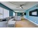 Spacious living room featuring wood floors, modern lighting, and a comfortable sofa with accent pillows at 3785 Decade St, Las Vegas, NV 89121