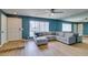 Comfortable living room featuring wood floors, modern lighting, and plush sofa with accent pillows at 3785 Decade St, Las Vegas, NV 89121