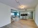 Spacious living room with hardwood floors and view to the kitchen and stairs at 3785 Decade St, Las Vegas, NV 89121