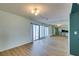 Open-concept living area with modern lighting, hardwood flooring, and views into the kitchen at 3785 Decade St, Las Vegas, NV 89121