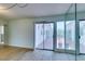 View of the patio through sliding glass doors and large windows with sheer curtains at 3785 Decade St, Las Vegas, NV 89121