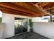 Enclosed patio featuring a sliding glass door, concrete flooring, and a wood beam ceiling at 3785 Decade St, Las Vegas, NV 89121