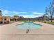 Community pool with a well-kept sundeck, lounge chairs, and shade in a fenced area at 3785 Decade St, Las Vegas, NV 89121