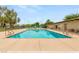 Inviting community swimming pool surrounded by a concrete deck, perfect for relaxation and recreation at 3785 Decade St, Las Vegas, NV 89121