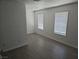 Bedroom featuring two bright windows, modern floors, and neutral paint at 3911 Torsby Pl, Las Vegas, NV 89119