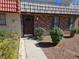 Townhouse featuring a brick facade, security door and low maintenance landscaping at 3911 Torsby Pl, Las Vegas, NV 89119