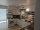 Updated kitchen with white appliances, granite countertops, and modern gray backsplash at 3911 Torsby Pl, Las Vegas, NV 89119