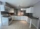 Bright kitchen featuring white cabinets, granite countertops and a subway tile backsplash at 3911 Torsby Pl, Las Vegas, NV 89119