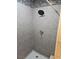 Modern shower with gray tiled walls, rainfall showerhead, and white tiled flooring at 3911 Torsby Pl, Las Vegas, NV 89119