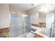 Bathroom featuring a frosted glass shower/tub, decorative wall, and updated vanity and countertop at 433 Jubilation Dr, Las Vegas, NV 89145