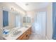 Bright bathroom with double sinks, a large vanity, and tiled floors for easy cleaning at 433 Jubilation Dr, Las Vegas, NV 89145