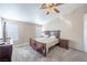 Bedroom featuring carpeted floors, a ceiling fan, and a large bed with decorative side tables at 433 Jubilation Dr, Las Vegas, NV 89145