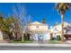 Charming two-story home features a tile roof, attached garage, and well-maintained landscaping with mature trees at 433 Jubilation Dr, Las Vegas, NV 89145