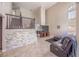 Open-concept living area with a stacked stone accent wall, large windows, and comfortable seating, creating a welcoming atmosphere at 433 Jubilation Dr, Las Vegas, NV 89145