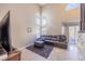Bright and airy living room with vaulted ceilings, large windows, and a comfortable seating area overlooking the backyard at 433 Jubilation Dr, Las Vegas, NV 89145