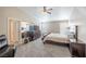 Spacious main bedroom with carpeted floors, a ceiling fan, and large mirror above the dresser at 433 Jubilation Dr, Las Vegas, NV 89145