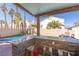 Outdoor kitchen and bar area providing ample seating with views of the pool and back yard at 433 Jubilation Dr, Las Vegas, NV 89145