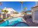 Sparkling in-ground pool with a built-in hot tub and outdoor kitchen area, perfect for entertaining at 433 Jubilation Dr, Las Vegas, NV 89145