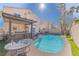 Beautiful pool and outdoor kitchen offering views of the two-story home and palm trees at 433 Jubilation Dr, Las Vegas, NV 89145
