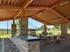 Enjoy a covered picnic area with stone pillars, picnic tables, and well-manicured landscape for outdoor relaxation at 4533 Queens Hill St, North Las Vegas, NV 89031