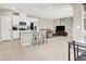 The kitchen overlooks the living area, featuring a large island, modern appliances, and stairs to the second floor at 4533 Queens Hill St, North Las Vegas, NV 89031