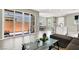 Bright living room with modern gray interior, tile floors, and large sliding glass doors to the exterior at 4533 Queens Hill St, North Las Vegas, NV 89031
