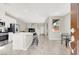 Open-concept living space featuring hardwood floors, a kitchen island, stainless appliances, and modern finishes at 4533 Queens Hill St, North Las Vegas, NV 89031