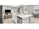The kitchen overlooks the living area, featuring a large island, modern appliances, and seating at 4533 Queens Hill St, North Las Vegas, NV 89031