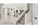 View of living space with stairs, island, and gray tile, creating a modern and inviting ambiance at 4533 Queens Hill St, North Las Vegas, NV 89031