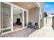 Cozy outdoor patio with brick pavers, seating, and sliding glass doors leading to interior at 4533 Queens Hill St, North Las Vegas, NV 89031