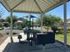 Shaded picnic area next to the playground with a table, grill, and view of play structures at 4533 Queens Hill St, North Las Vegas, NV 89031