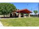 Relaxing outdoor picnic area with stone accents, covered seating, and green landscape for a pleasant gathering space at 4533 Queens Hill St, North Las Vegas, NV 89031