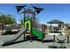 Community playground area with a slide, swings, and shaded picnic tables under blue skies at 4533 Queens Hill St, North Las Vegas, NV 89031