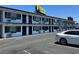 White two-story building with parking, showing many numbered doors and barred windows along its length at 4600 Paradise Rd # 16, Las Vegas, NV 89169