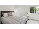 Sunlit bedroom with a bed near a window and light gray wood-look floors, promoting a tranquil atmosphere at 4753 Carefree Dr, Las Vegas, NV 89122
