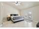 Relaxing primary bedroom with ceiling fan, tiled floors, and a glass door leading to a private patio area at 4753 Carefree Dr, Las Vegas, NV 89122