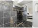 Modern bathroom featuring a step-in shower with decorative tilework and an open doorway to the main bedroom at 4753 Carefree Dr, Las Vegas, NV 89122