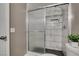 This bathroom features a shower with marble tile and a sliding glass door at 507 Satin Saddle Pl, Henderson, NV 89052