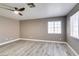 This bedroom features wood flooring, neutral paint, a ceiling fan, and natural light at 507 Satin Saddle Pl, Henderson, NV 89052